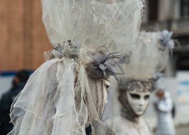 People wearing colorful and elaborate costumes during the Venice carnival in Italy 