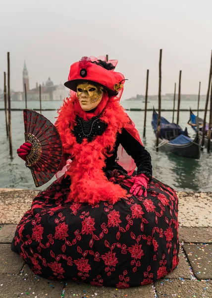 People wearing colorful and elaborate masks and costumes during the Venice carnival in Italy