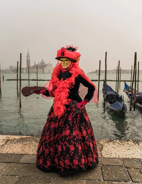 People wearing colorful and elaborate masks and costumes during the Venice carnival in Italy