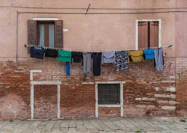 Clothes hung out to dry outside an old building in Venice, Italy