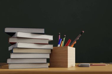 A pencil case and stacked textbooks with a blackboard in the background, 3d rendering