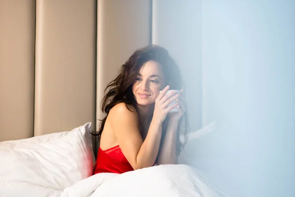 Caucasian Beautiful Young Brunette Female Sitting Bed Red Sleepwear Holding — Fotografia de Stock