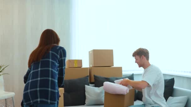 Happy Young Caucasian Couple Unpacking Stuff Cardboard Boxes New House — Stok Video