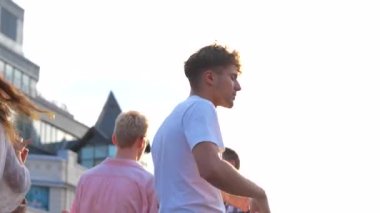 Mutlu gençler çatıda birlikte dans ederken eğleniyorlardı. Yaşam tarzı, arkadaşlık, eğlence konsepti. Gerçek zamanlı.