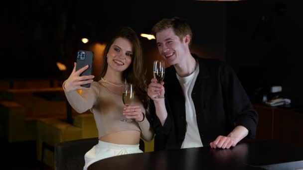 Leende Unga Par Njuter Kvällen Restaurangen Samtidigt Som Tar Selfie — Stockvideo
