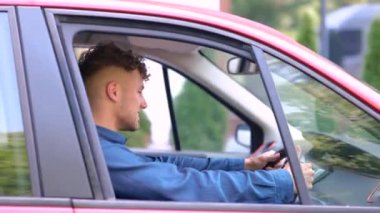 Şoför koltuğunda oturup direksiyonda el ele tutuşan mutlu adam. Sağ el sürücüsü araba. Yaşam tarzı, seyahat, ulaşım konsepti. Gerçek zamanlı.