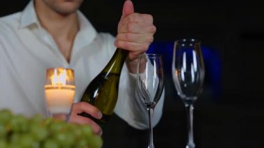 Akşam romantik bir randevu sırasında erkek el ele tutuşup şampanya koyuyor. Çatıda romantik bir randevu. Romantik bir kavram. Birbirine aşık bir çift. Gerçek zamanlı.