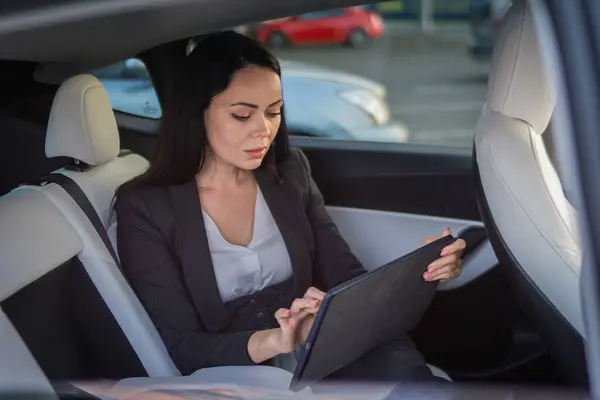 Menina Bonita Digitando Tablet Digital Enquanto Sentado Banco Trás Carro — Fotografia de Stock
