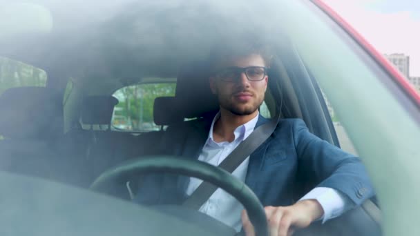Happy Young Man Glasses Holding Hand Steering Wheel While Driving — Stock Video