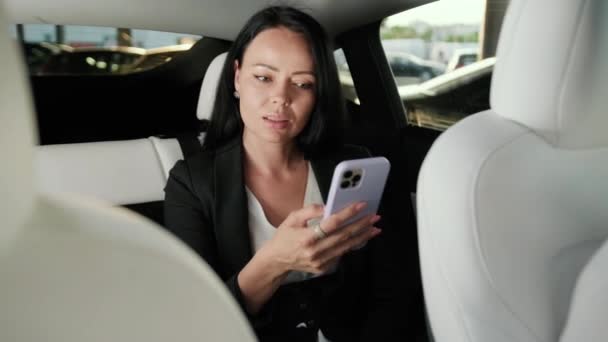 Young Lady Holding Mobile Phone Texting Message Sitting Car Back — Stock Video