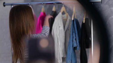 Mutlu güzel bayan kameraya gri süveterini gösterirken evde internetten gelen kıyafetlerin reklamını yapıyor. Stilist etkileyicisi video blogu çekiyor. Küçük işletme, çevrimiçi pazar konsepti. - Evet. Gerçek zamanlı video.