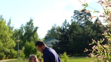Close up portrait of happy young handsome father throw up his cute daughter in park. Cheerful parent playing with teen child throwing her into sky. Family day, happy childhood. Parenting style concept