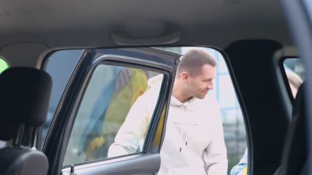 Young Caring Father Opens Car Door Helps His Teenager Daughter — Stock Video