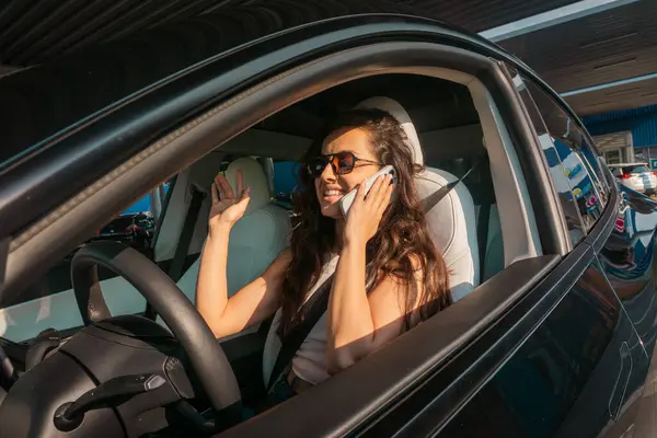 Giovane Donna Felice Indossando Occhiali Sole Durante Guida Auto Parlando — Foto Stock