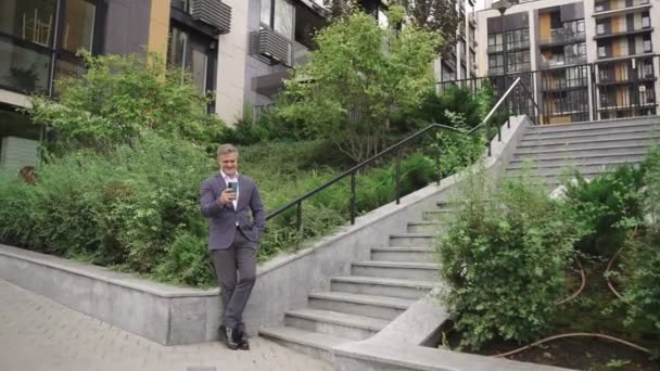 Happy Businessman Using Mobile Phone While Posing Outdoors Steps Business — Stock Video