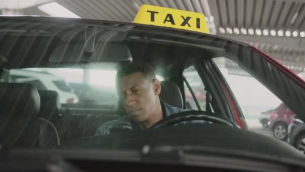 市内のポジティブなアフリカ系アメリカ人のタクシー運転手 黄色いタクシー車の屋根サイン サービスコンセプト スローモーション — ストック動画