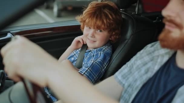 Smiling Little Son Using Seat Belt While Looking His Father — Stock Video
