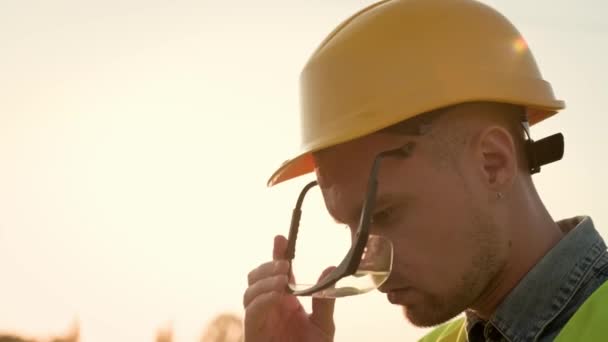 Closeup Portrait Construction Worker Hard Hat Putting Safety Goggles Smiling — Stock Video