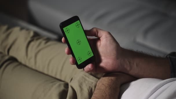 Young Man Sitting Sofa Holding Phone Chroma Key Green Screen — Vídeo de Stock
