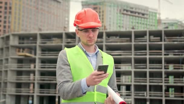 Construction Superintendent Blueprints Hand Smiling Scrolling Newsfeed Mobile Phone Unfinished — Stock Video