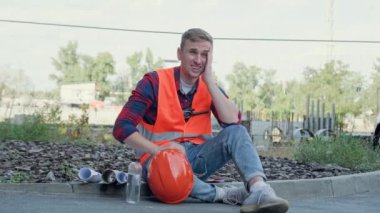 Yorgun müteahhit kaldırıma oturmuş iç çekiyor ve alnını ovuyordu. Yavaş çekim