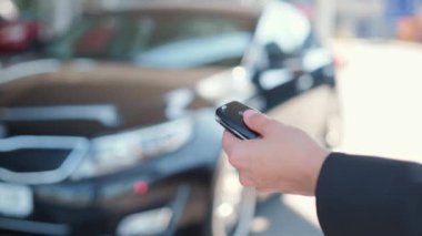 Kadının elektronik araba anahtarlığı taşıdığı videoyu kapat ve düğmeye bas, araba alarmını çalıştır. Yavaş çekim videosu