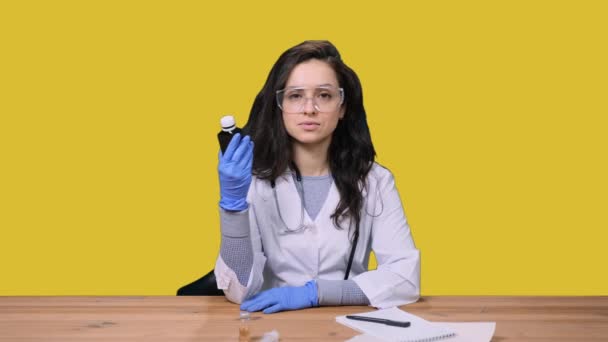 Female Doctor Uniform Stethoscope Protective Gloves Showing Bottle Medicine Sitting — Stock Video
