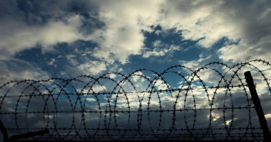 Barbed Wire Fences and Clouds. clipart