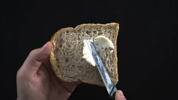 Butter Slice Bran Bread Eating Breakfast Black Table Spreading Butter — Stock Photo, Image