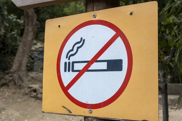 No smoking sign in the forest, outdoor no smoking notice, smoking addiction concept, healthy lifestyle idea