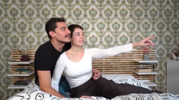 Young Couple Sitting Bed Pointing Something Window Beautiful Couple Looking — Video Stock