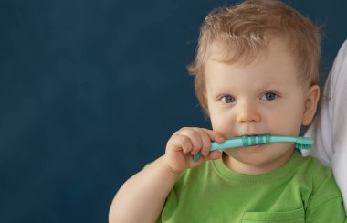 Cute baby 2 years old brushes his teeth with a toothbrush. The concept of oral hygiene and healthy teeth from infancy.