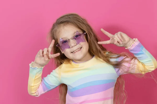 迷人可爱的小女孩戴着星形太阳镜的肖像 嘴巴张开的孩子在粉色背景下被隔离得很开心 看着摄像机 哇可笑的脸 — 图库照片
