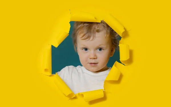 Little Surprised Baby Boy Looking Peeping Bright Yellow Paper Hole — Stockfoto