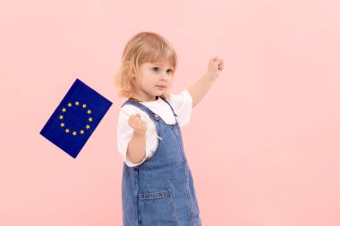 Elinde pembe arka planda Avrupa Birliği bayrağını tutan tatlı bir kız çocuğu. Savaşta devletlerin birliğini destekleme kavramı