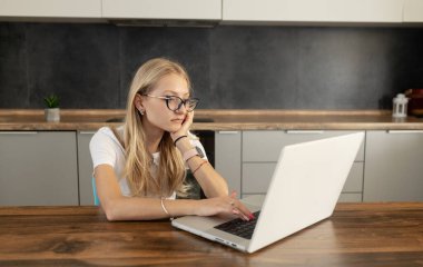 Yorgun kız başını dizüstü bilgisayarın yanındaki masaya yasladı, evdeki mutfak masasında oturdu. Şehvetli ya da iş kadınlarının mesafeli çalışmaları. Sınavlar için zor hazırlık