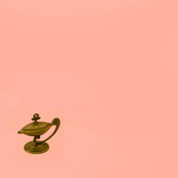 Genie lamp for wishing success to the company on orange background.
