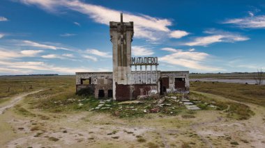 Old Epecuen slaughterhouse abandoned by flooding on a partly cloudy day clipart