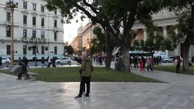 Plaza de Mayo 'daki Buenos Aires katedralinin önünde yürüyen turistler.