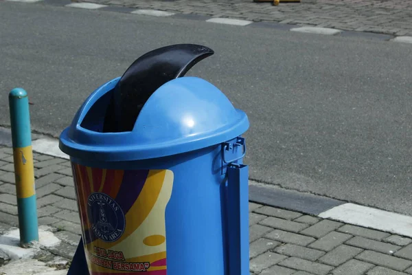 Stock image Medan, Indonesia, february 2023 - blue trash can on the side of the road.  empty trash can on the sidewalk.  no trash on the streets.  streets that look clean from trash