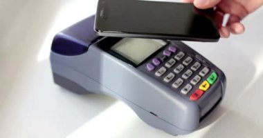 NFC teknolojisi POS aygıtı EMV terminal ödeme nakitsiz cüzdanı olan akıllı telefonu ödeme aracı olarak kullanan kişi