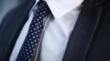 Genç iş adamı kravatı ayarlıyor. Zarif adamın kısmi görüşünü bağlayıp düzeltiyorum.