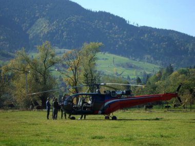Dağlarda sonbahar helikopter turu sırasında çayırda eşsiz bir mola ve sigara molası. Fotoğraf 2 Ekim 2019 Çarşamba günü saat 12: 11 'de Ukrayna' nın İvano-Frankivsk bölgesinde Verkhovyna köyünde çekildi.