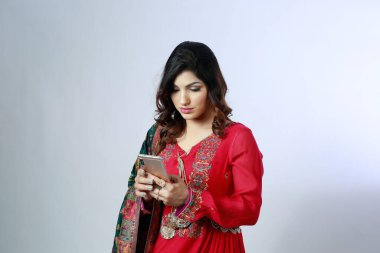 Genç ve güzel Hintli Pakistanlı Desi 'nin telefon ekranında Kamiz Shalwar kıyafeti var..