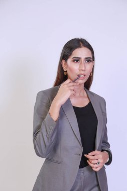 Young entrepreneur woman thinking for a solution while Giving a presentation to a client or colleagues. Successful business woman in a formal suite. Isolated on White background