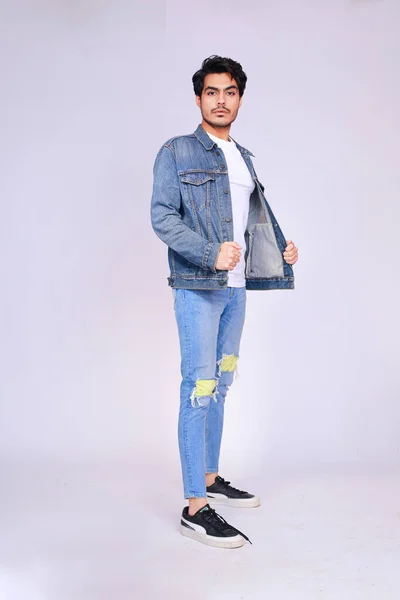 Young attractive asian male model, wearing denim jacket and pants, posing men\'s fashion and style on a white studio background