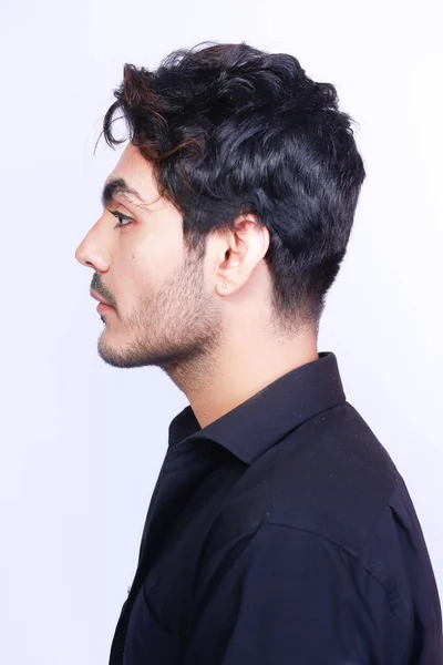 Side profile portrait of a man with a pierced ear