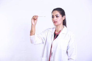 Pakistani Asian Desi Doctor worried looking at the patient's temperature. Concerned medical worker