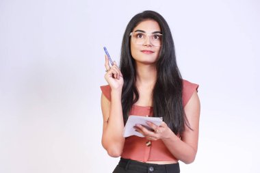 photo of beautiful student lady holding pad raised pen with smile have excellent idea startup wear specs casual top isolated on studio background