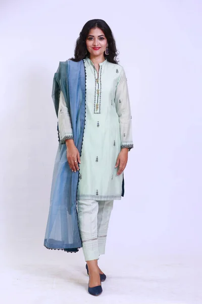 Beautiful Pakistani Woman in traditional embroidery shalwar kameez dress with dupatta. `Desi Fashion Concept